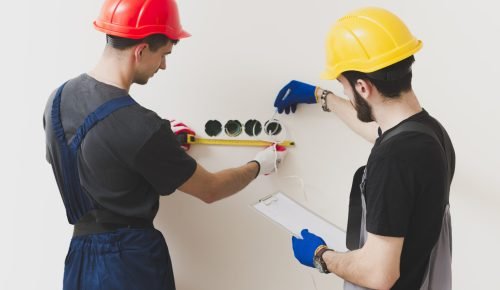 two-repairmen-making-measures-wall